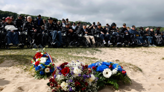 American D-Day veterans gather for a ceremony on Omaha Beach