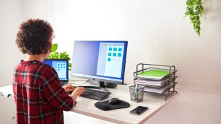 Woman,Typing,On,Computer,At,An,Adjustable,Standing,Desk,,On