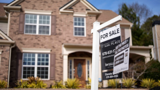  A sign announcing a home for sale is posted outside a home