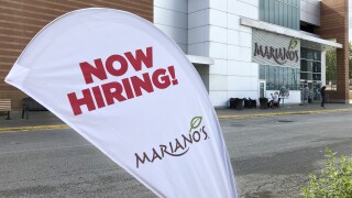 A sign in the parking lot of Mariano's grocery store advertises the availability of jobs