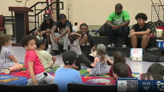 Lincoln High football players reading to kids